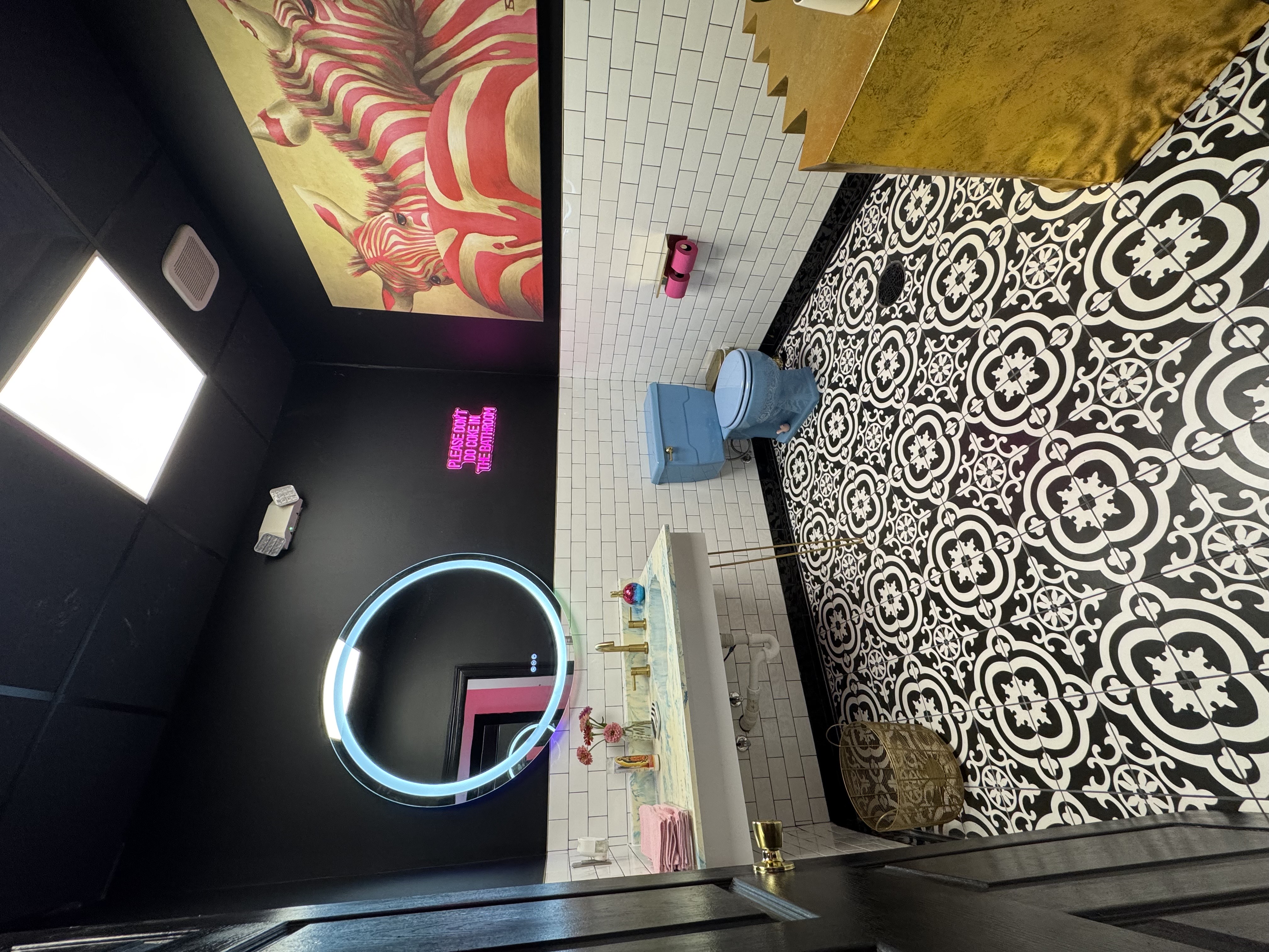 Patina Hair Studio restroom with neon mirror